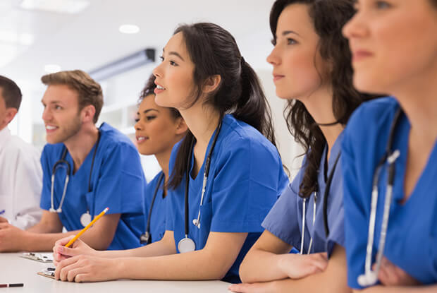 Medical students listening sitting at desk at the university