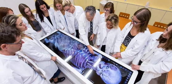 A group of medical students using a medical equipment