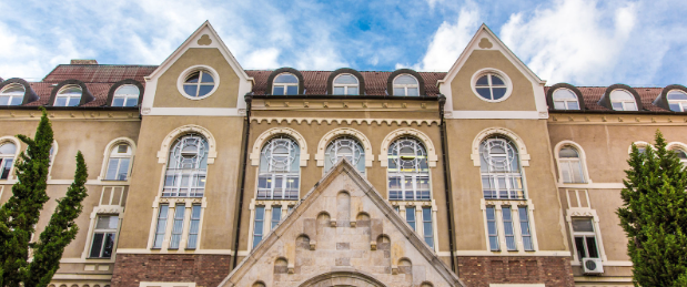 A low view of the building of the University of Pecs