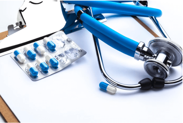 Empty prescription lying on a table with a stethoscope.