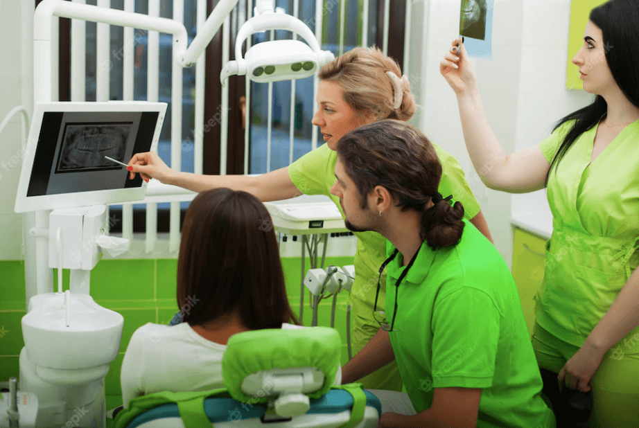 A young woman with a bright smile sitting in a dental office reception area.