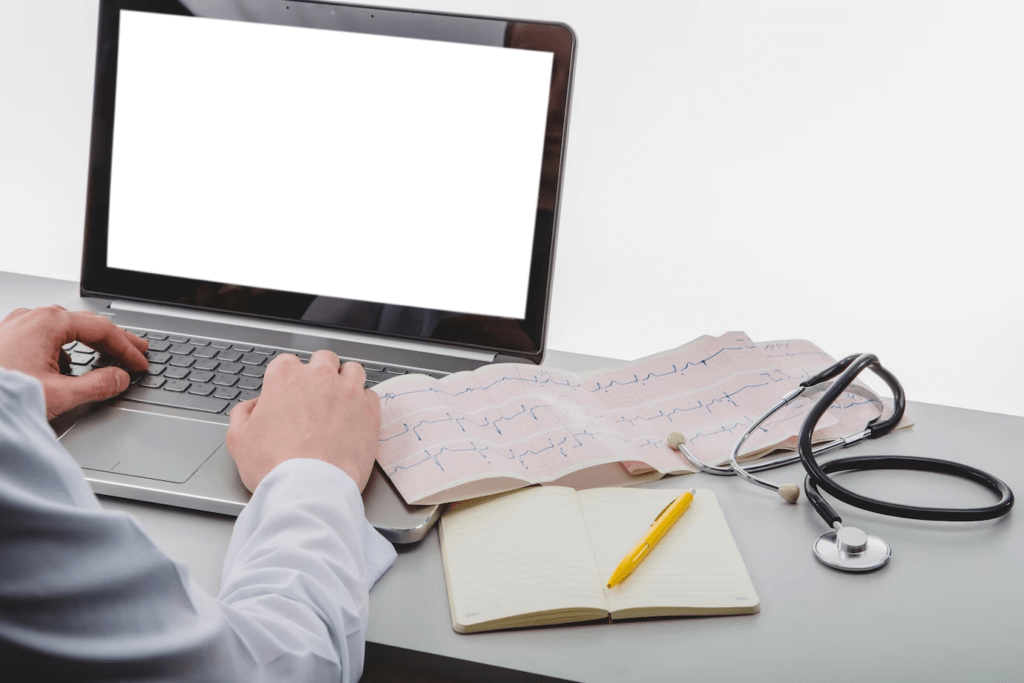 Unrecognisable medic typing on a laptop.