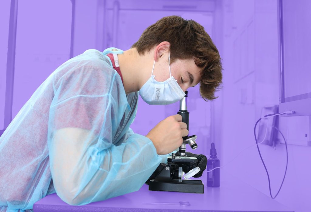 Student looking through a microscope