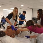 Three students learning how to take care of a hospice patient